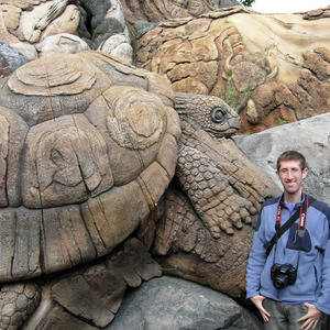 Me with a carving of a giant tortoise on the Tree of Life