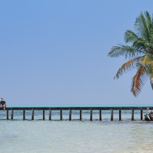 Paul sitting on a dock on Hathifushi Island