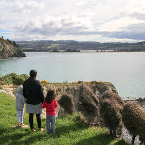 Adam, Iko, and Sophie above Purakaunui Bay