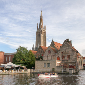 Old Saint-John and Church of Our Lady on a canal in Bruges