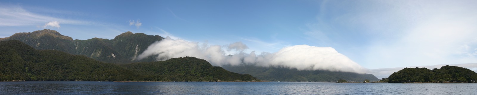 Cloud-covered mountains at the end of Doubtful Sound panorama